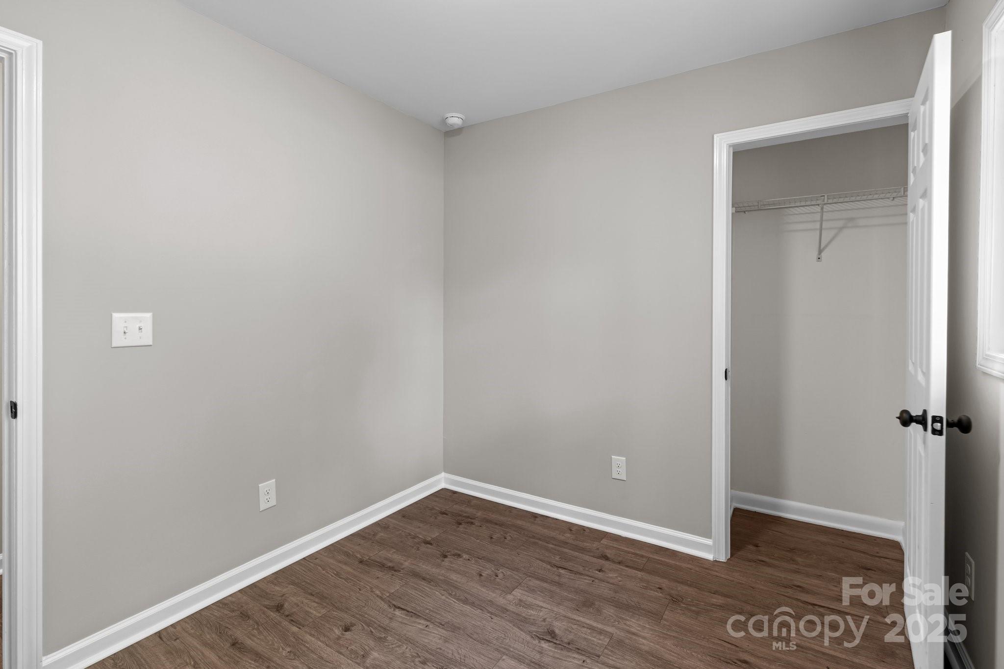 880 Legion Club Road Salisbury, NC 28146 - Photo 15 of 35 an empty room with wooden floor and closet