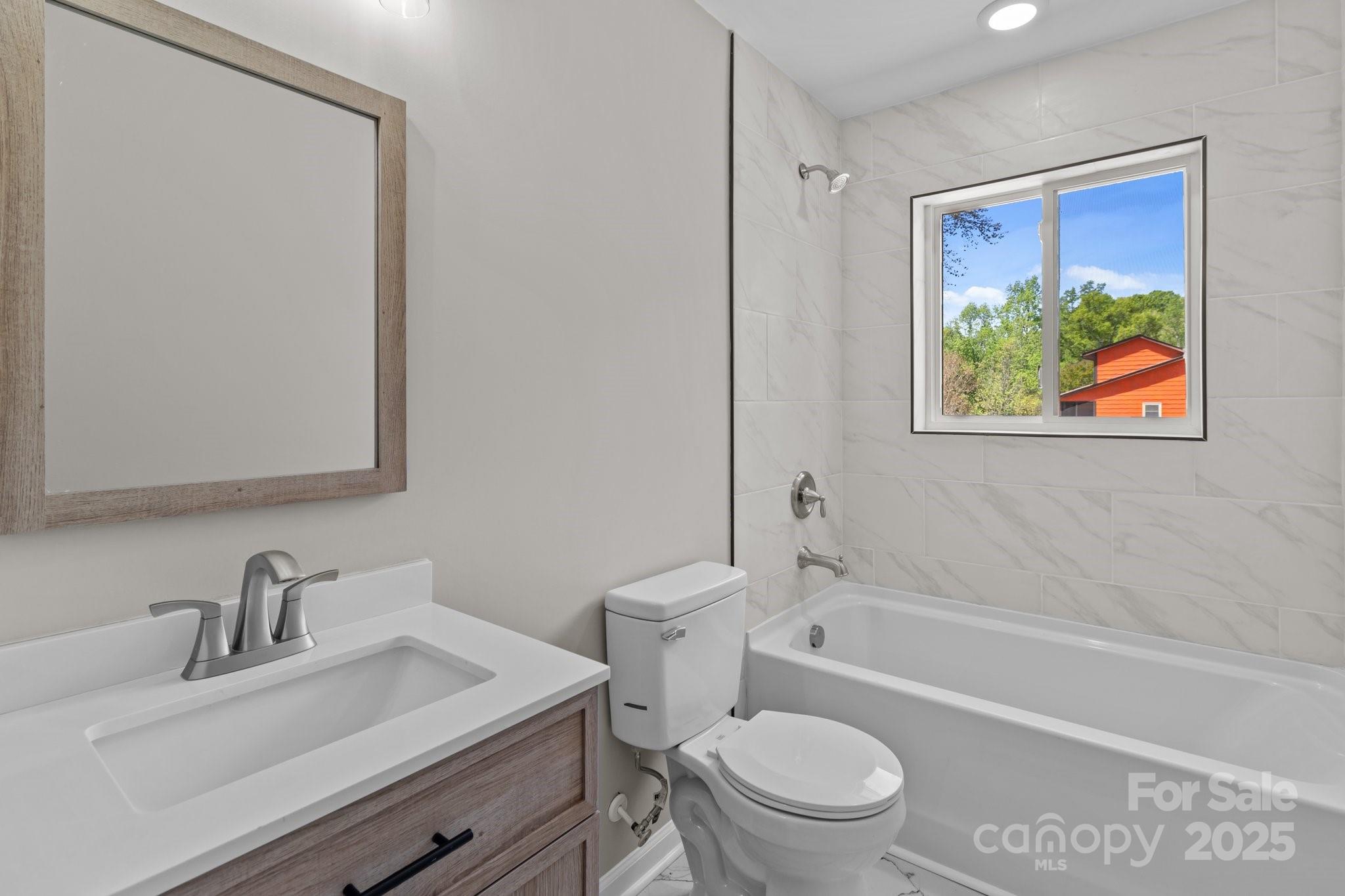 880 Legion Club Road Salisbury, NC 28146 - Photo 16 of 35 a bathroom with a sink a toilet and a bathtub