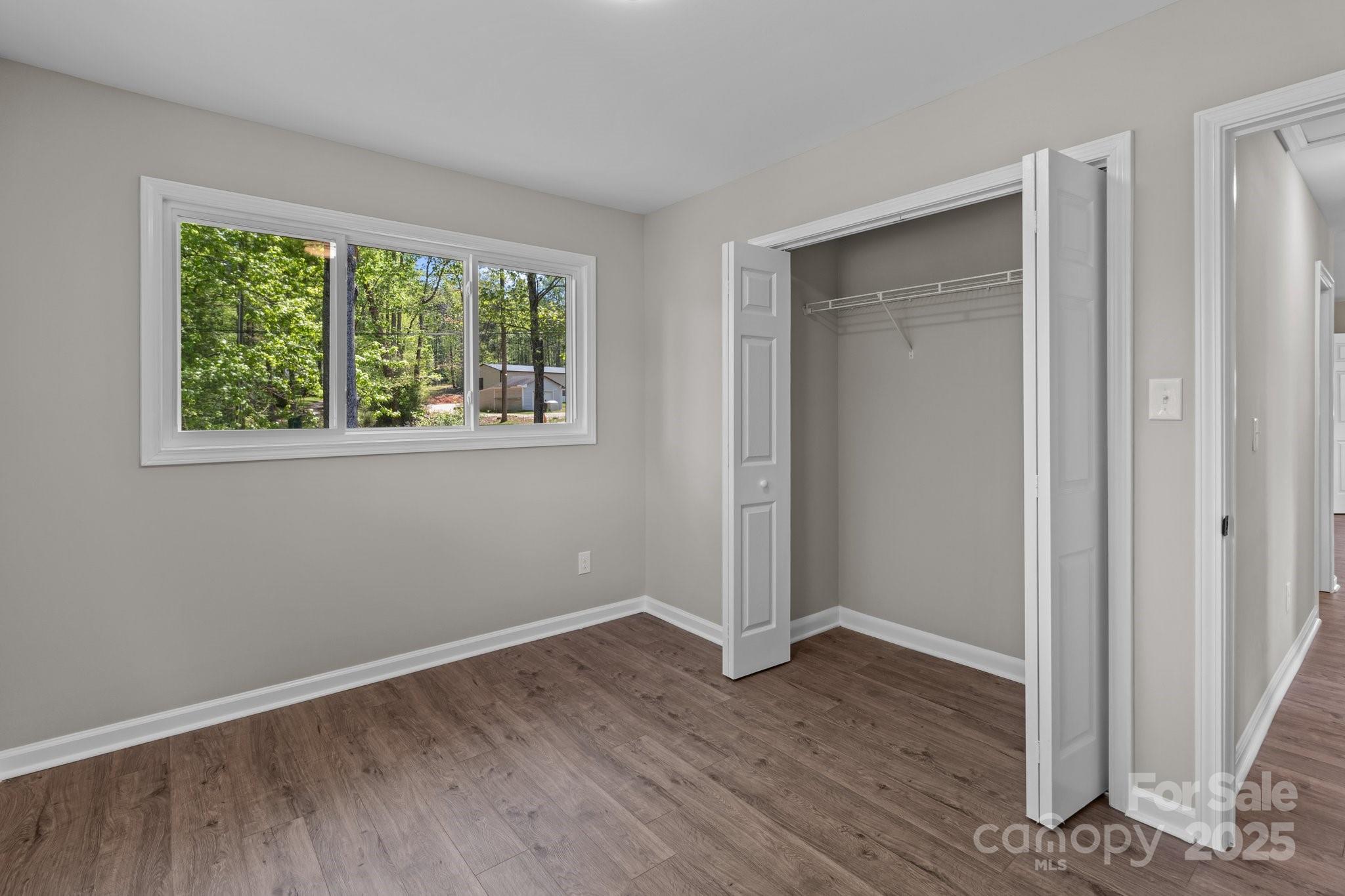 880 Legion Club Road Salisbury, NC 28146 - Photo 19 of 35 a view of an empty room with wooden floor and a window