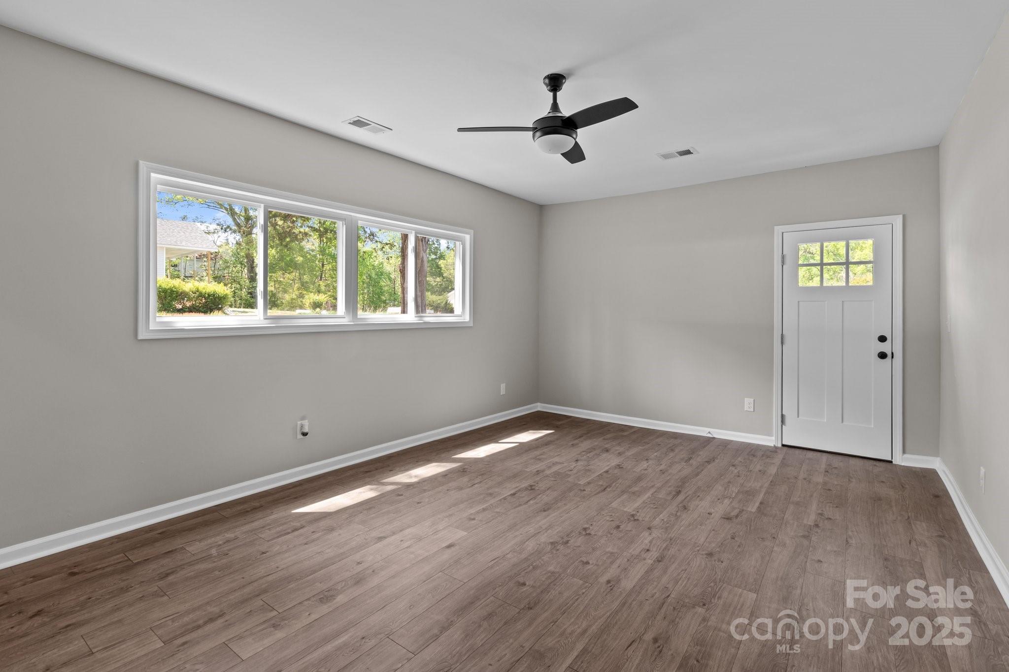 880 Legion Club Road Salisbury, NC 28146 - Photo 24 of 35 a view of empty room with wooden floor and fan