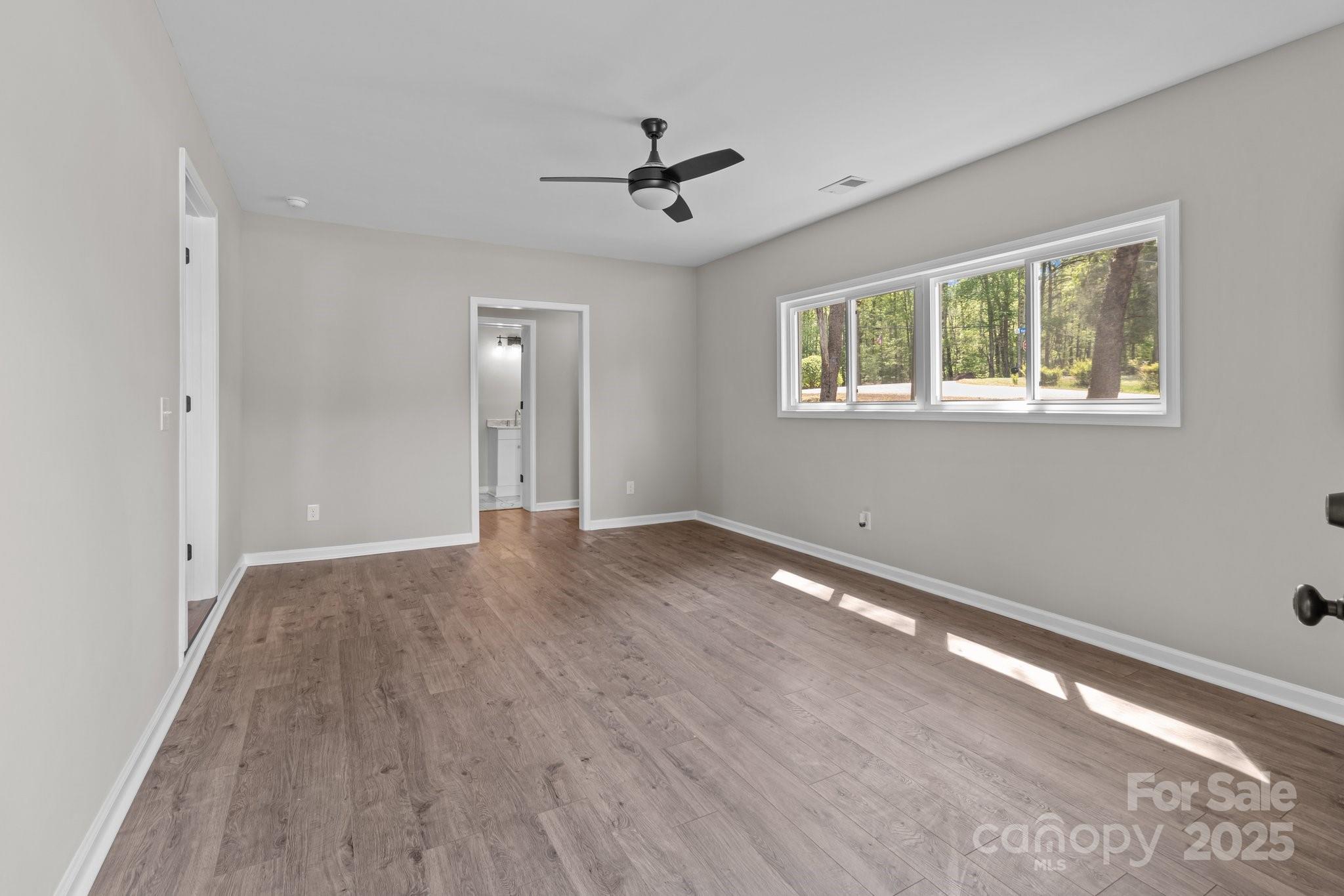 880 Legion Club Road Salisbury, NC 28146 - Photo 25 of 35 a view of an empty room with wooden floor and a window