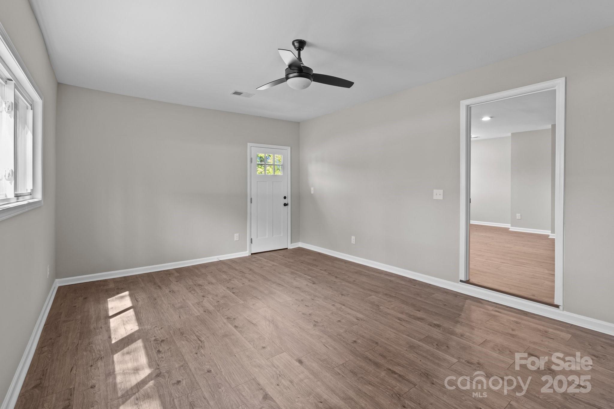 880 Legion Club Road Salisbury, NC 28146 - Photo 26 of 35 an empty room with wooden floor and windows