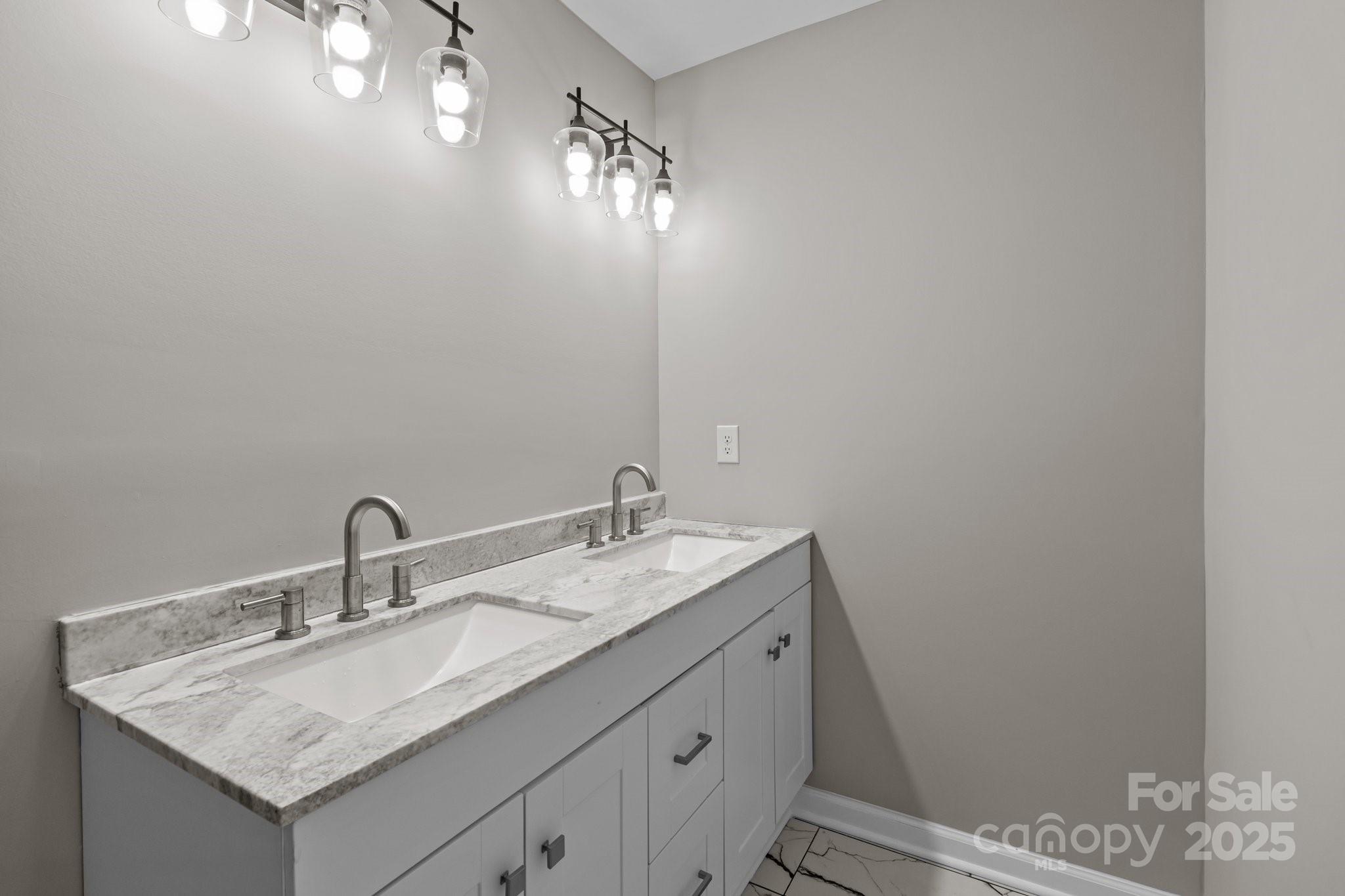 880 Legion Club Road Salisbury, NC 28146 - Photo 29 of 35 a bathroom with a sink and a mirror