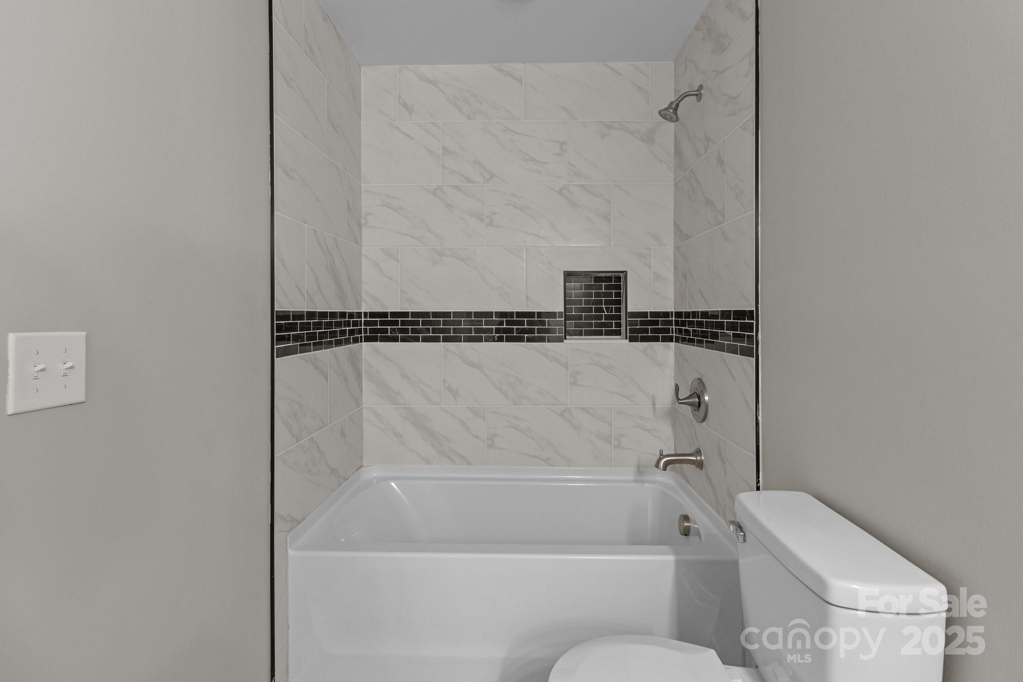 880 Legion Club Road Salisbury, NC 28146 - Photo 30 of 35 a bathroom with a bathtub and a toilet
