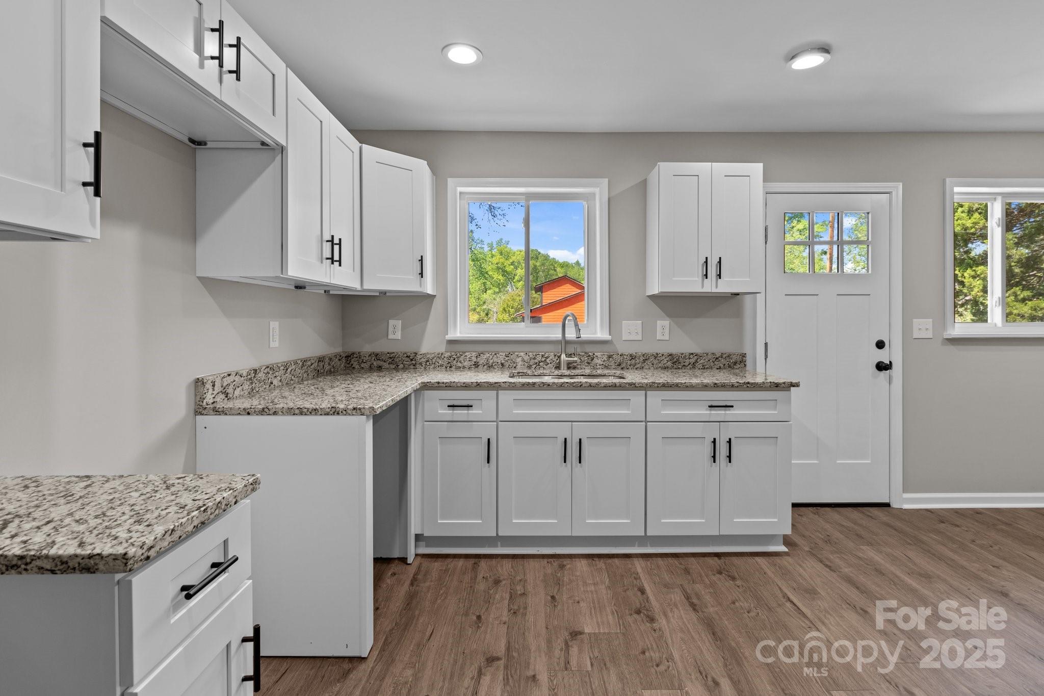 880 Legion Club Road Salisbury, NC 28146 - Photo 8 of 35 a kitchen with granite countertop cabinets stainless steel appliances and a wooden floor