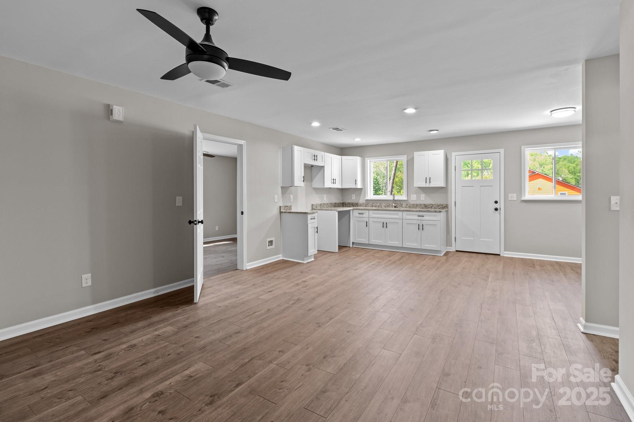 880 Legion Club Road Salisbury, NC 28146 - Photo 10 of 35 a large kitchen with a wooden floor and window