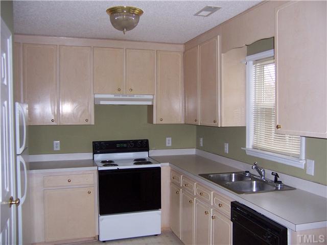1439 Lee Road Clayton, NC 27520 - Photo 4 of 10 a kitchen with a sink stove top oven and cabinets