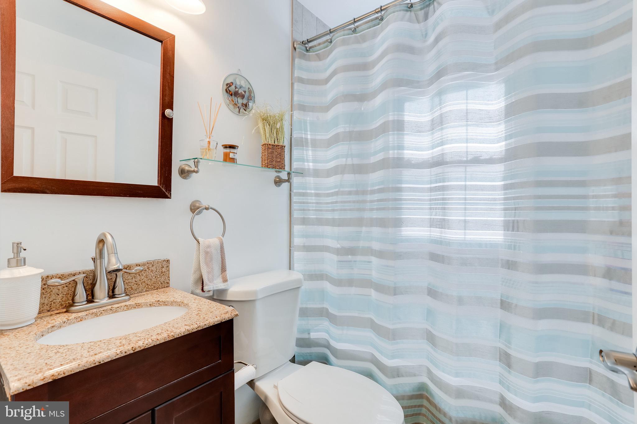 1214 Elm Road Halethorpe, MD 21227 - Photo 16 of 17 Bathroom features custom tile and window in shower