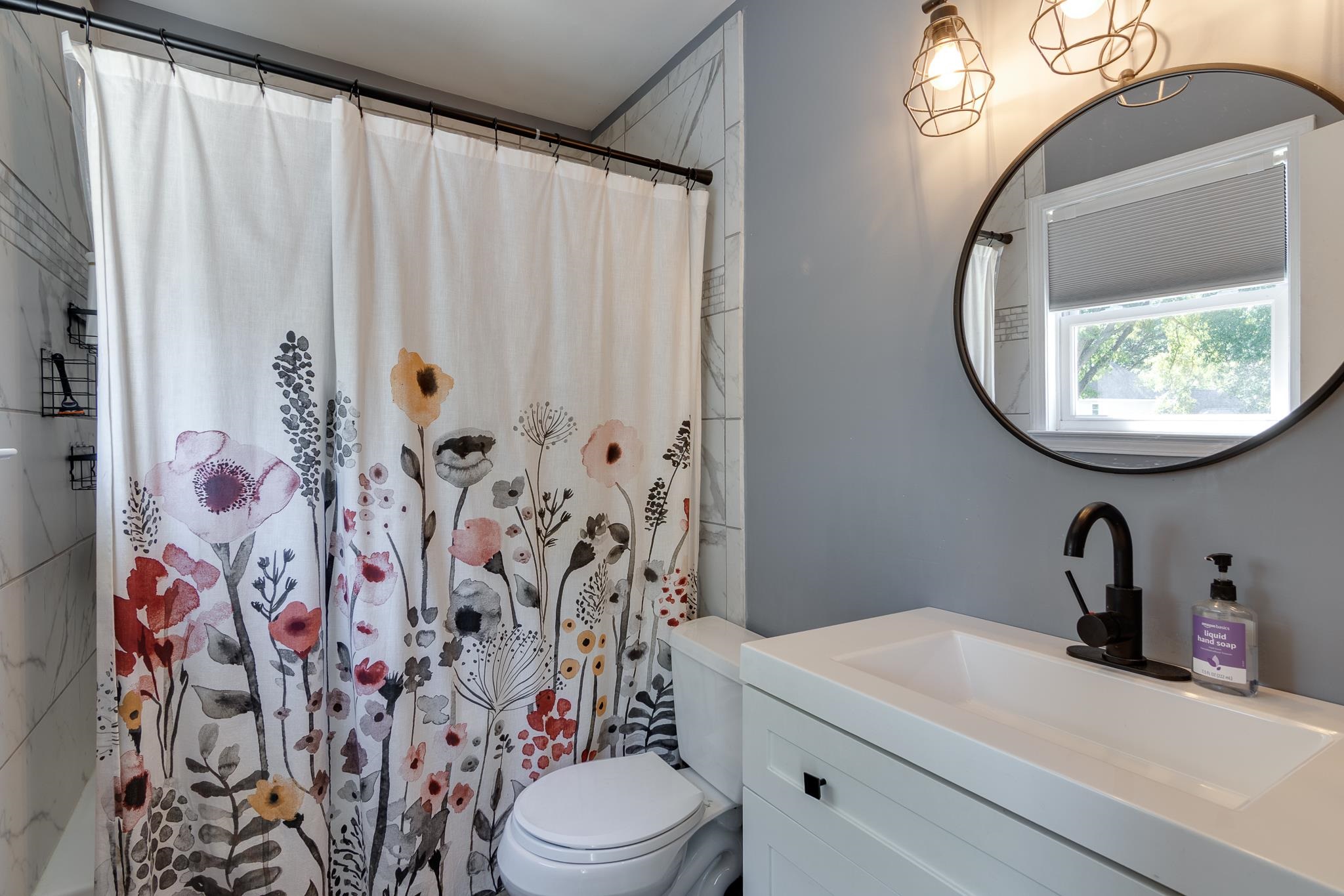 608 King Ridge Cove Collierville, TN 38017 - Photo 18 of 29 White vanity with integrated sink, matte black faucet, and circular mirror