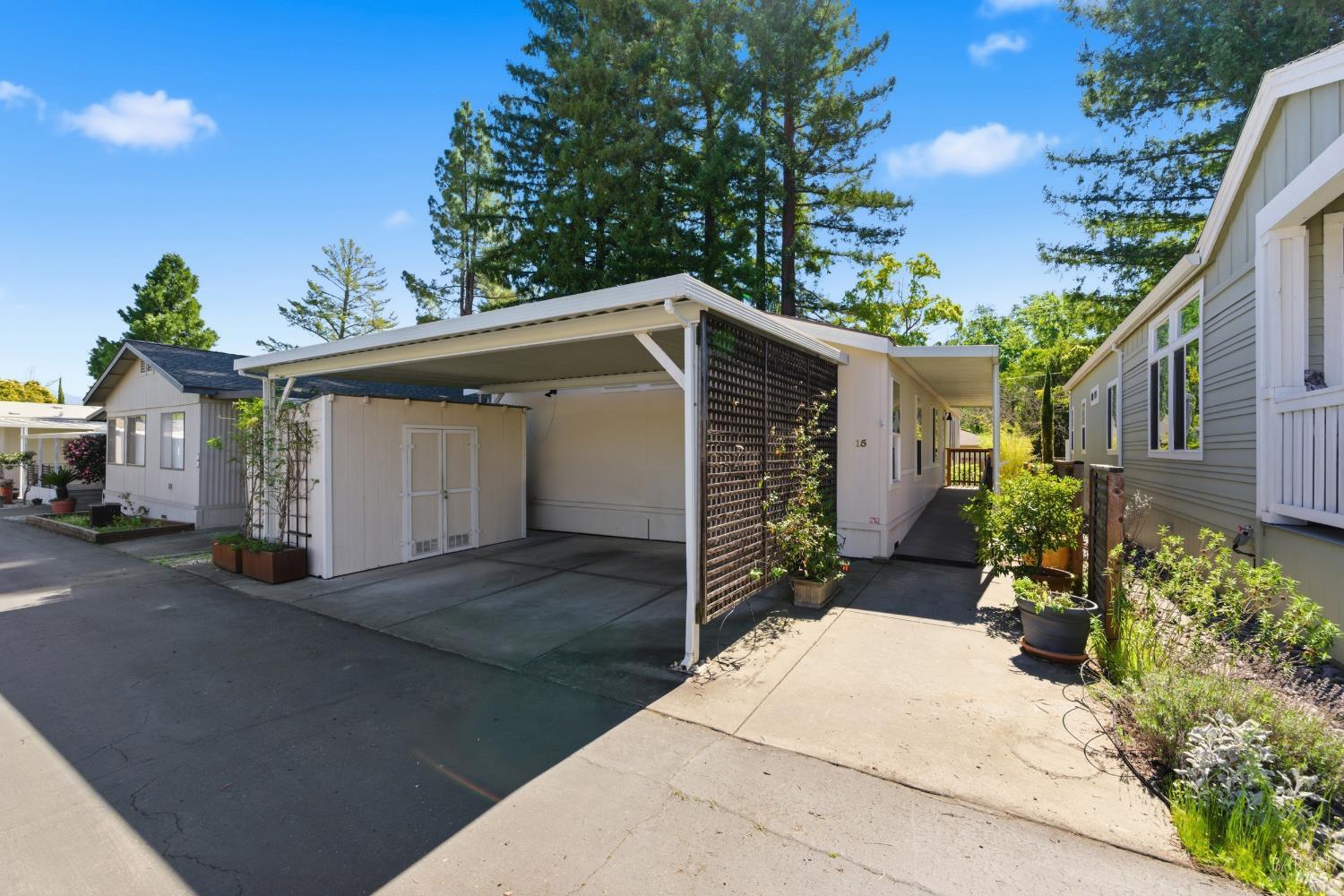 a view of a house with a yard and potted plants