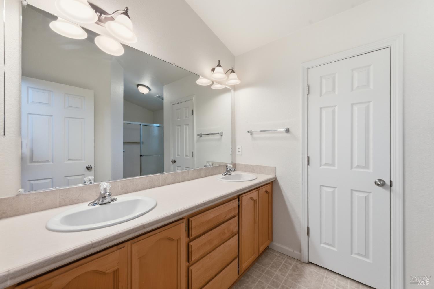 2412 Foothill Boulevard, Unit 15 Calistoga, CA 94515 - Photo 12 of 16 a bathroom with a sink a light fixture and a mirror