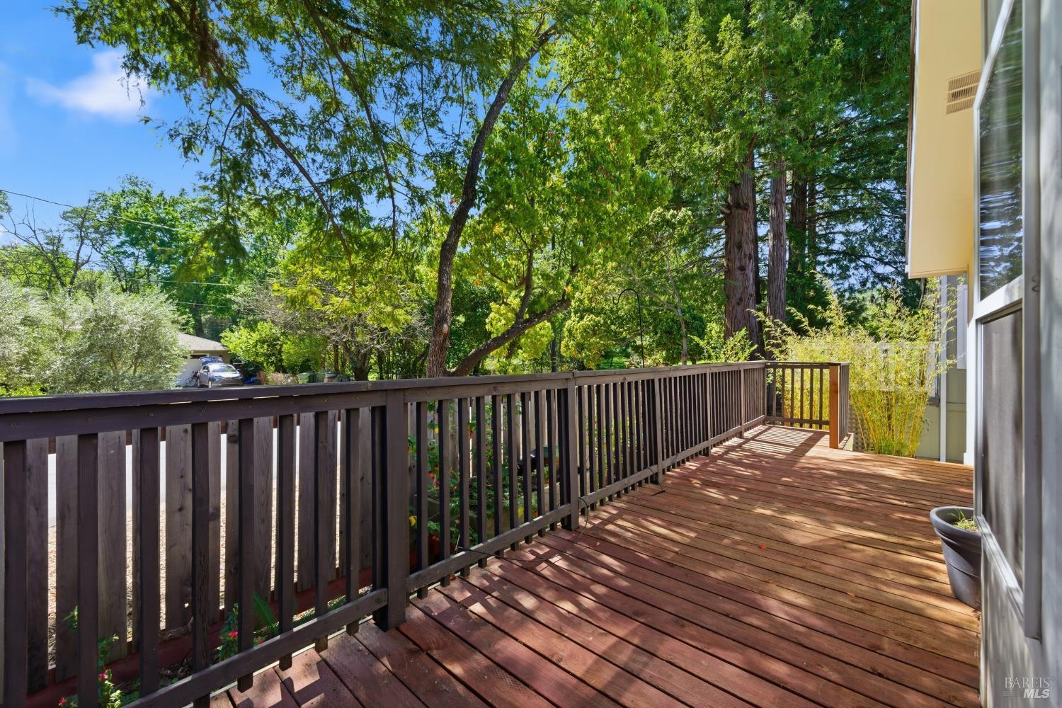 2412 Foothill Boulevard, Unit 15 Calistoga, CA 94515 - Photo 16 of 16 a balcony with wooden floor and fence