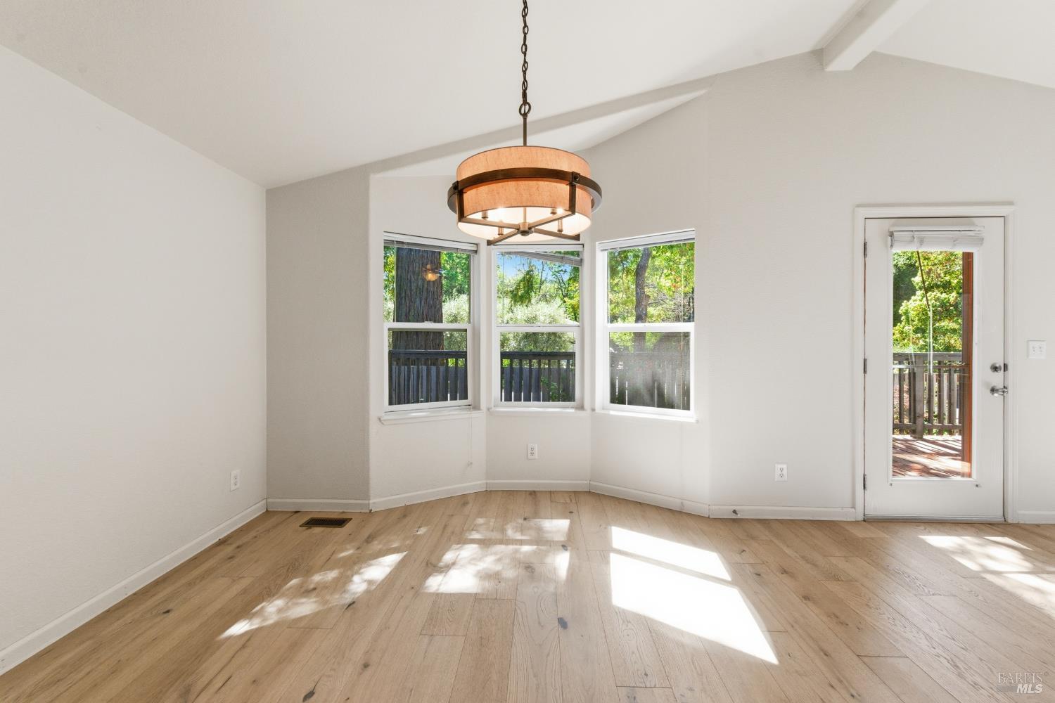 2412 Foothill Boulevard, Unit 15 Calistoga, CA 94515 - Photo 5 of 16 a view of an empty room with window and chandelier fan