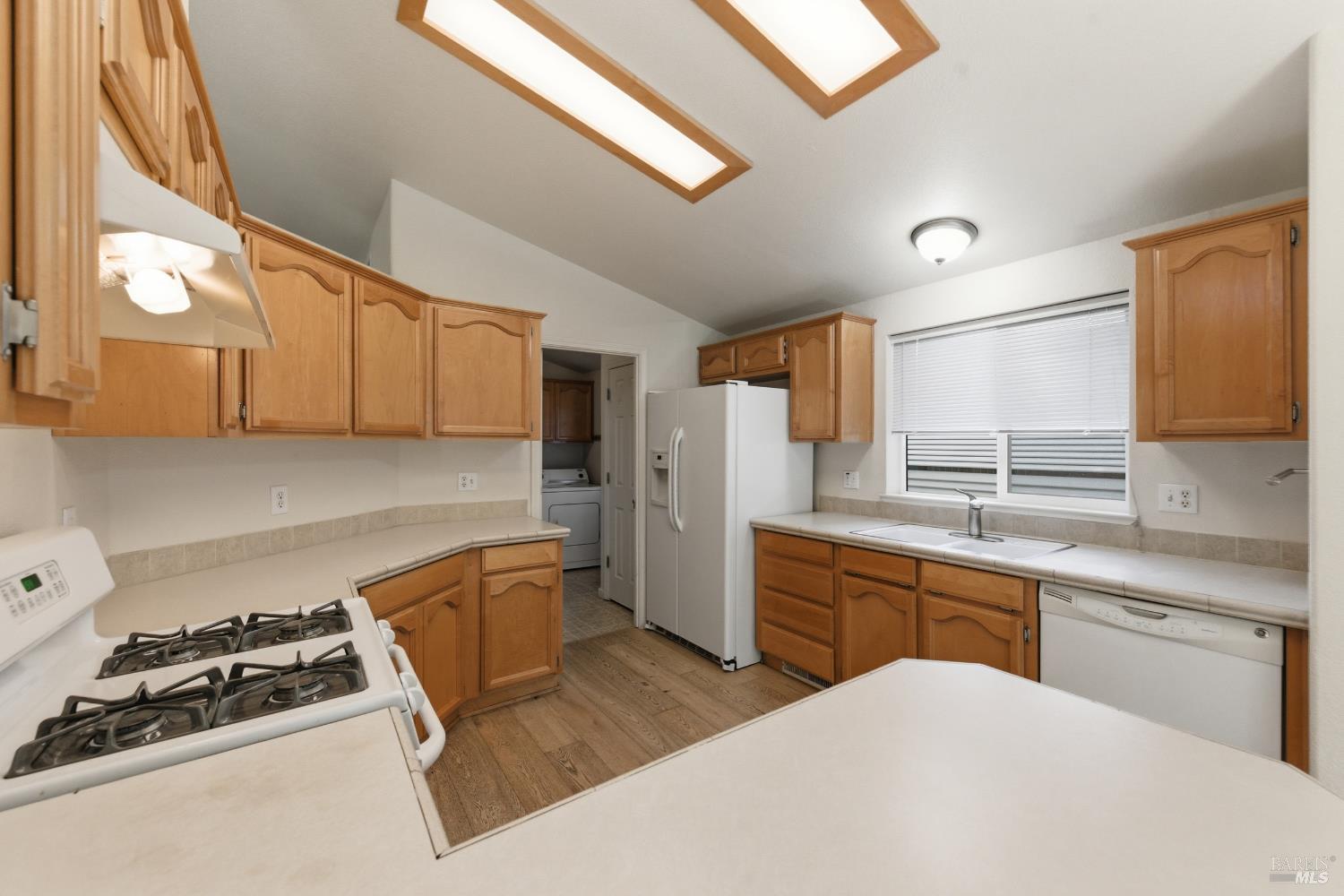 2412 Foothill Boulevard, Unit 15 Calistoga, CA 94515 - Photo 7 of 16 a kitchen with a stove a sink and a refrigerator