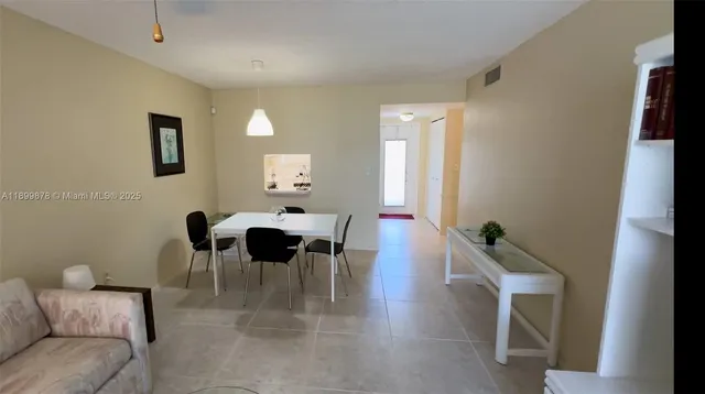 a living room with furniture and a lamp