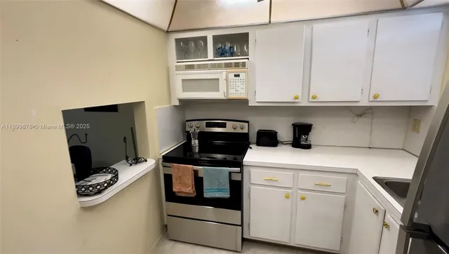 a kitchen with stainless steel appliances granite countertop a stove and a refrigerator