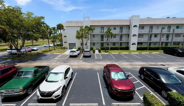 a front view of a house with swimming pool and furniture