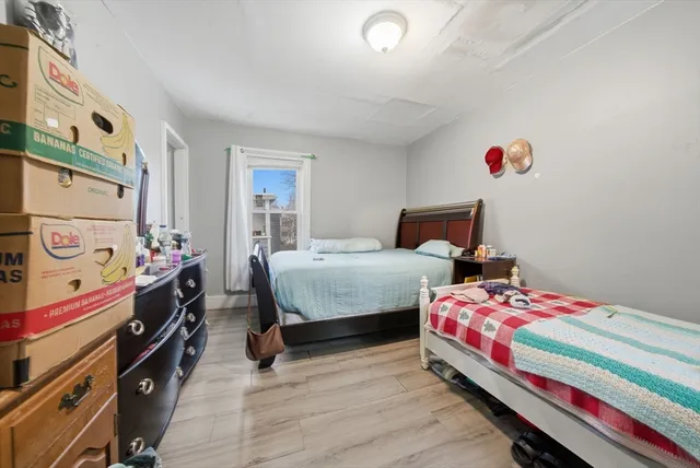 a bedroom with two beds and a dresser