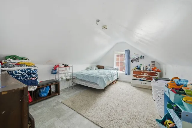 a bedroom with furniture and a baby crib