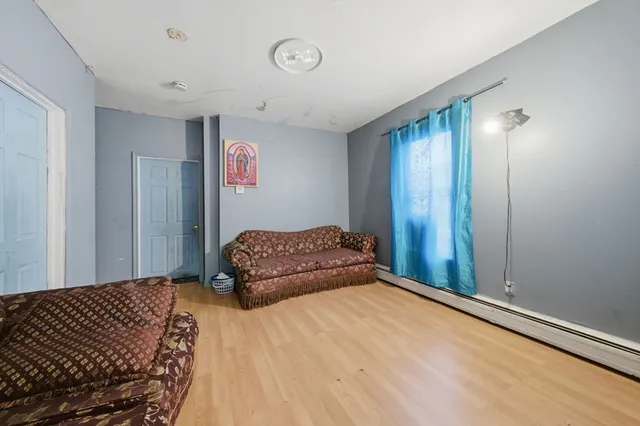 a bedroom with a bed and a painting on the wall