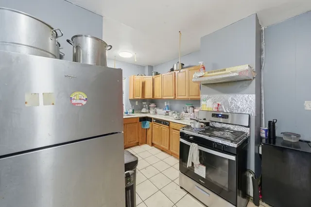 a kitchen with stainless steel appliances a refrigerator a sink and a stove