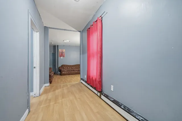 a view of a room with wooden floor