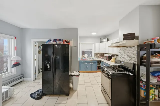 a kitchen with stainless steel appliances granite countertop a refrigerator and a stove