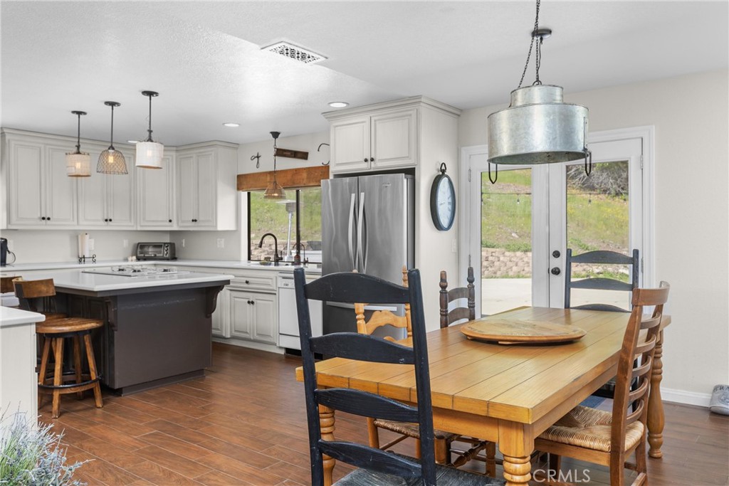 7330 Gage Irving Road Paso Robles, CA 93446 - Photo 11 of 30 a kitchen with stainless steel appliances granite countertop a stove a refrigerator a kitchen island a sink and a refrigerator