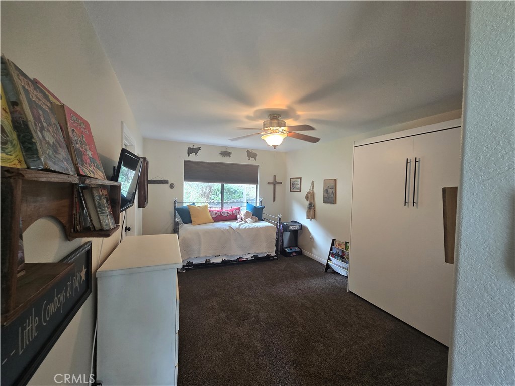 7330 Gage Irving Road Paso Robles, CA 93446 - Photo 17 of 30 a bedroom with a bed and a chandelier
