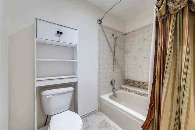 a bathroom with a toilet a sink and bathtub