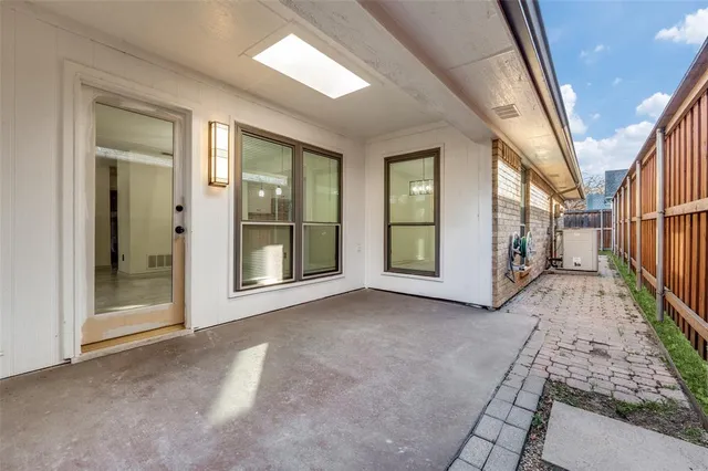 a view of a hallway with wooden floor and windows