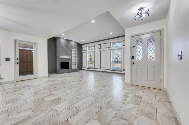 a view of an empty room with a fireplace