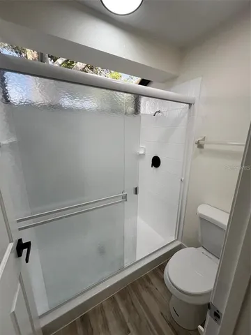 a bathroom with a toilet and a shower