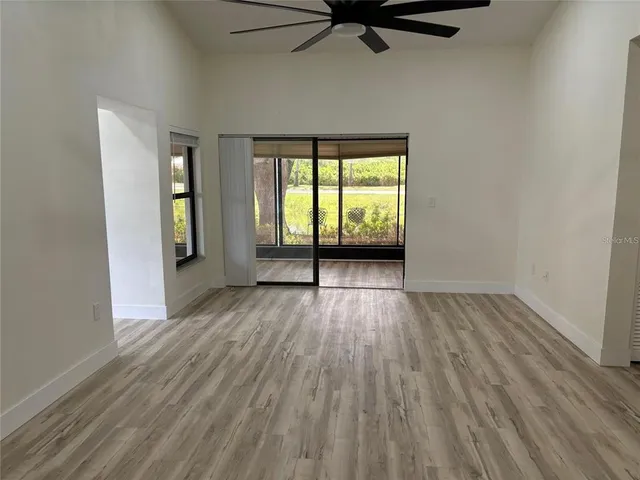 wooden floor in an empty room with a window