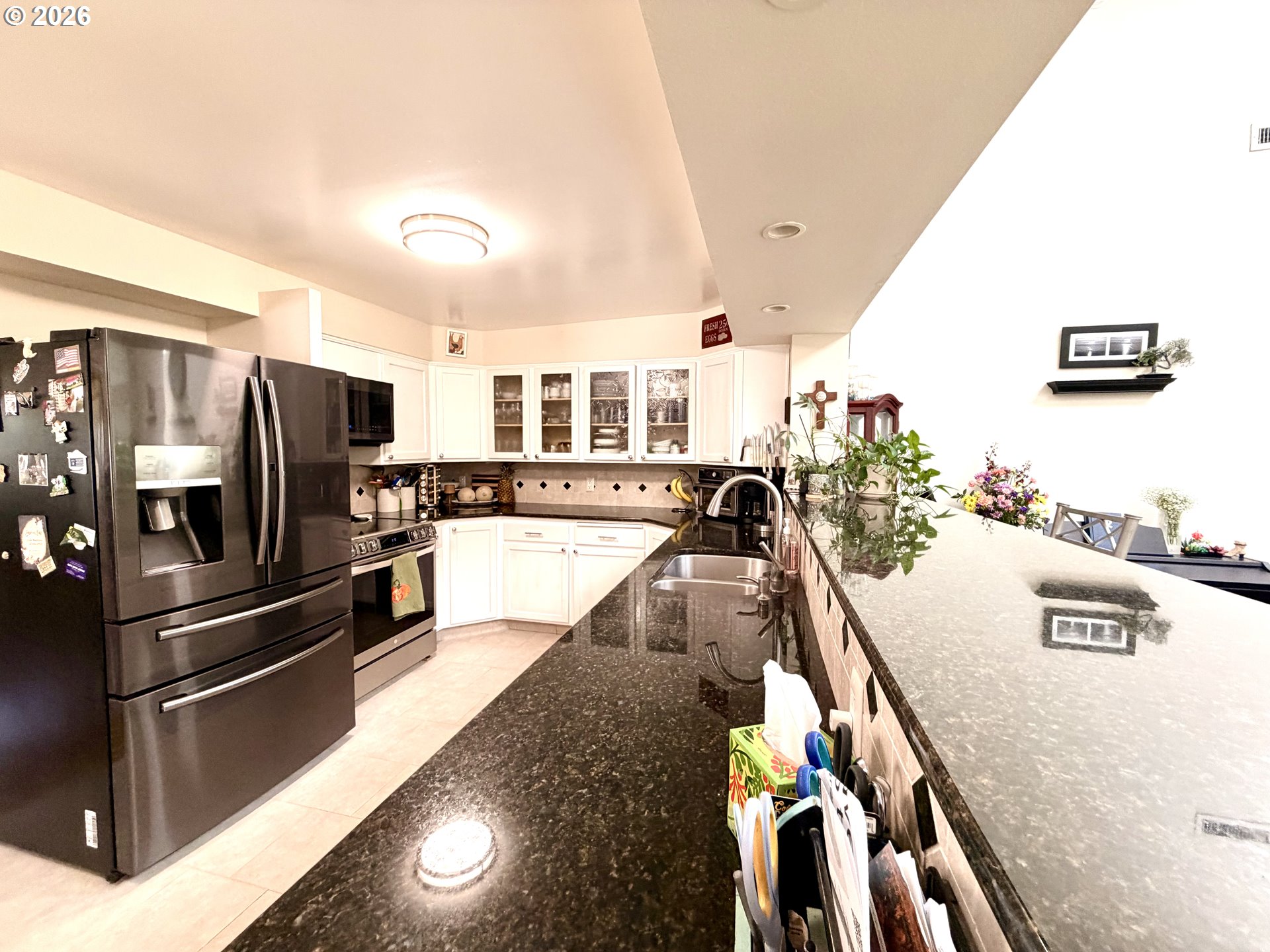 1401 Northeast 267th Avenue Camas, WA 98607 - Photo 6 of 16 a kitchen with stainless steel appliances granite countertop a refrigerator a stove and a sink with wooden floor