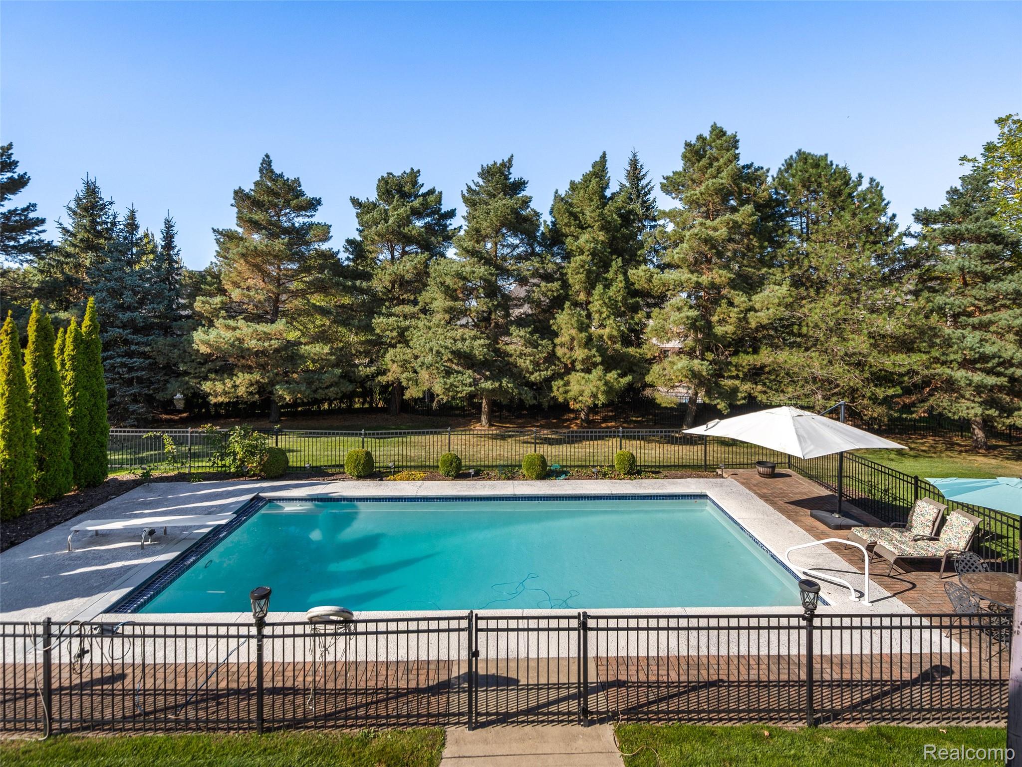 5724 Murfield Drive Rochester, MI 48306 - Photo 29 of 99 View of swimming pool with a patio area and a diving board
