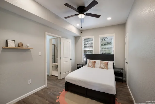 a bedroom with a large bed and a chandelier