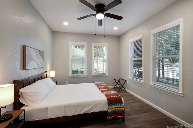 a bedroom with a bed and wooden floor
