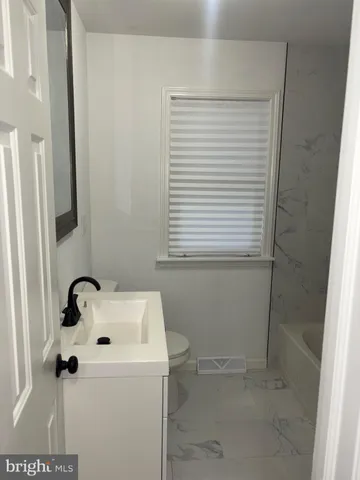 a bathroom with a sink and a window