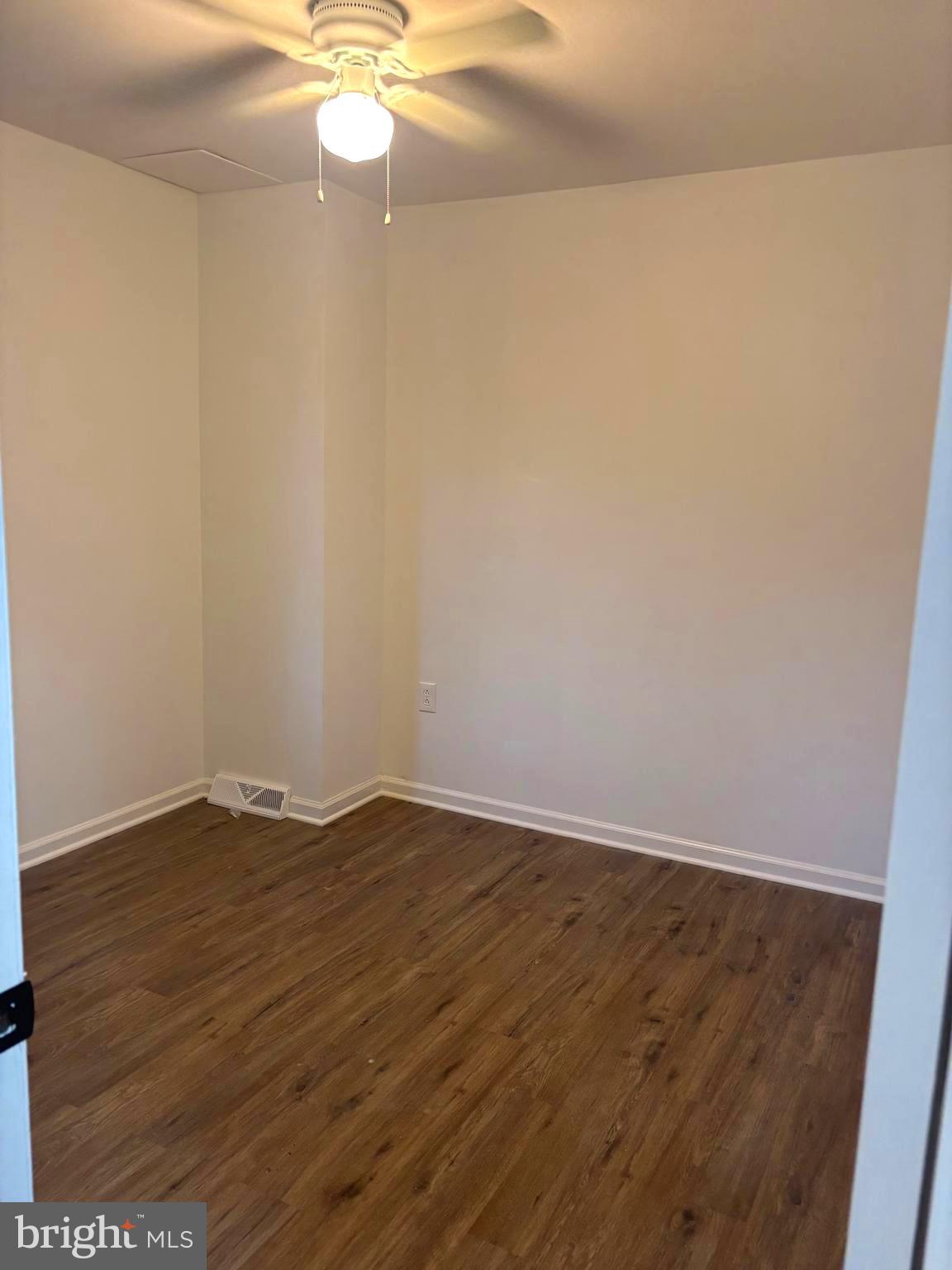 4216 West 7th Street Trainer, PA 19061 - Photo 12 of 26 a view of an empty room with wooden floor and a window