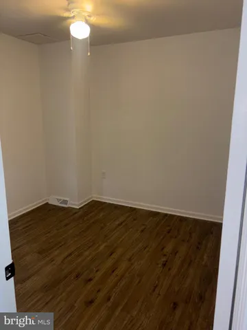 a view of wooden floor and brick wall