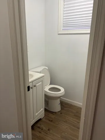 a white toilet sitting next to a shower