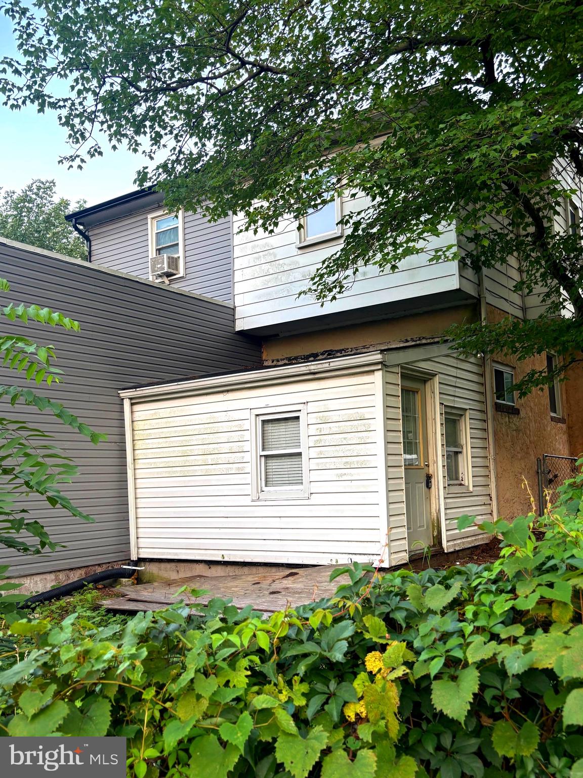 4216 West 7th Street Trainer, PA 19061 - Photo 23 of 26 a small white house with a flower garden in front of it