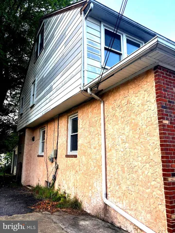 a side view of a house with a yard