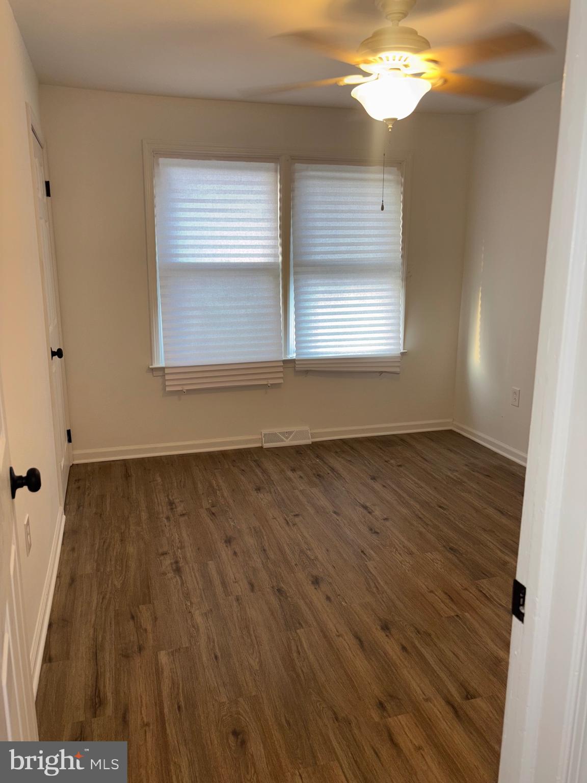 4216 West 7th Street Trainer, PA 19061 - Photo 25 of 26 a view of an empty room with wooden floor and a window