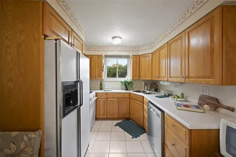 a kitchen with a sink stove and refrigerator