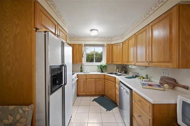 a kitchen with a sink stove and refrigerator
