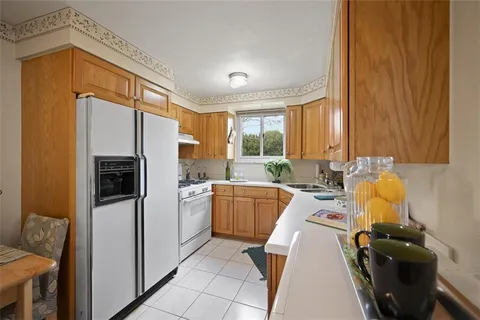 a kitchen with a refrigerator and a stove top oven