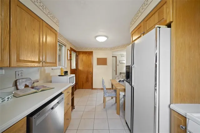 a kitchen with a sink appliances and cabinets