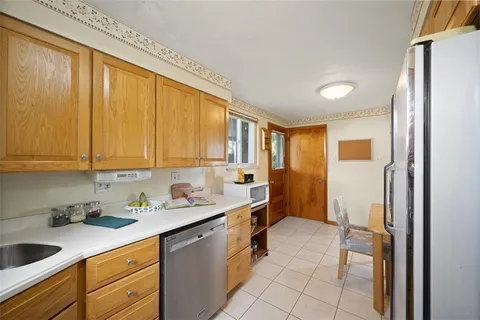 a kitchen with a sink a refrigerator and cabinets